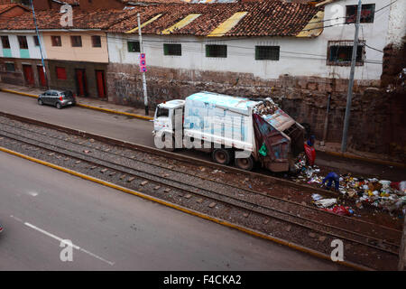 Truck collecting garbage next to former railway line on Av del Ejercito, Cusco, Peru Stock Photo