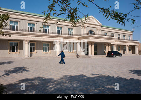 China, Xinjiang Uyghur, Fukang. A man walks towards the Fukang branch of the Citic Guoan Winery, formerly Suntime Winery. Stock Photo