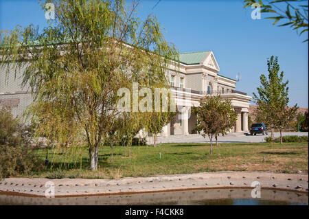 China, Xinjiang Uyghur, Fukang. A pond and trees surround the Fukang branch of the Citic Guoan Winery, formerly Suntime Winery. Stock Photo