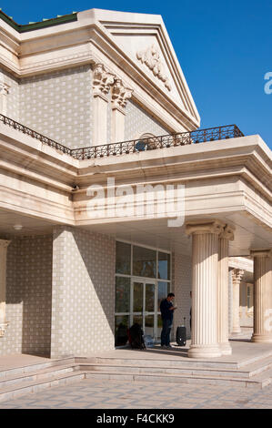 China, Xinjiang Uyghur, Fukang. A lone person stands under the portico of the Fukang branch of the Citic Guoan Winery, formerly Suntime Wine Company. Stock Photo