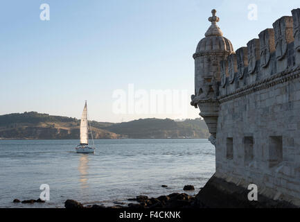 schip is sailing on the Tagus river in front of the Belem tower in Lisbon Portugal Stock Photo