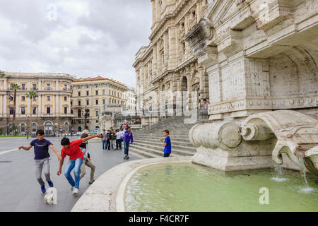 Italian teens playing football next to the Palace of Justice in Piazza Cavour square,  Rome, Italy Stock Photo