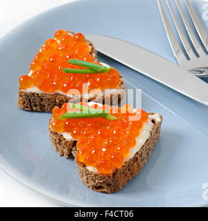 sandwich with red caviar in the form of a heart Stock Photo