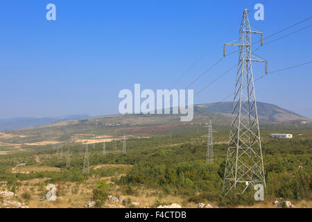 Electrical towers carrying power lines across Bosnia-Herzegovina Stock Photo