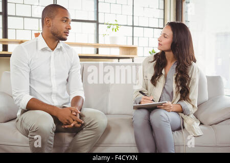 Counselor listening to patient at clinic Stock Photo