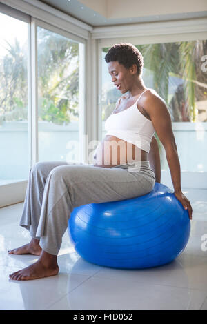 Pregnant woman sitting on exercise ball Stock Photo