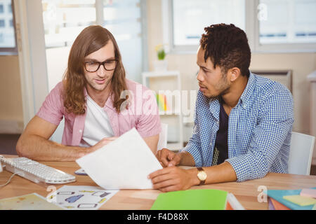 Businessmen discussing over document Stock Photo