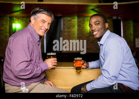 Smiling colleagues having a drink together Stock Photo