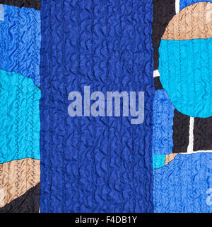 textile background from stitched wrinkled blue silk fabric and patchwork Stock Photo
