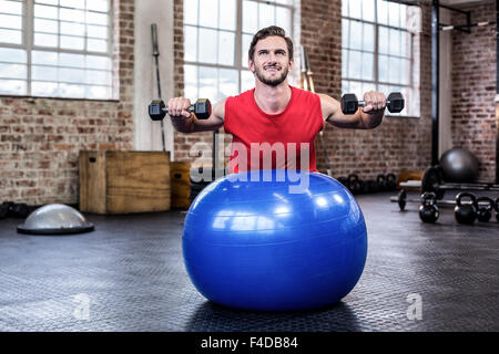 Young man exercising with dumbbells Stock Photo