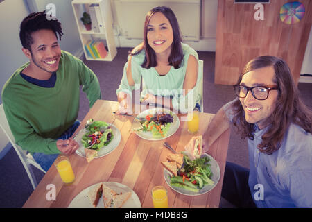 Portrait of happy creative business people having breakfast Stock Photo