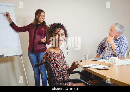 Happy businesswoman on wheelchair using smartphone Stock Photo