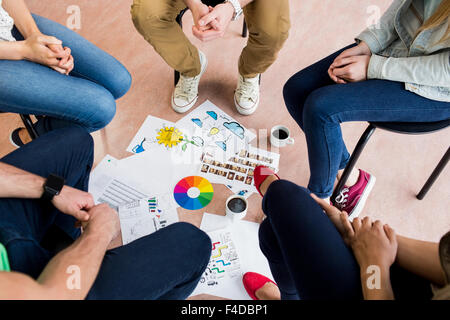 Students sitting in circle working together Stock Photo