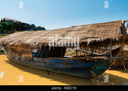 Wooden boat on muddy river Stock Photo