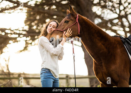 Young happy woman with her horse Stock Photo
