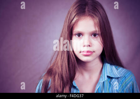 Studio shot of a beautiful 11 years old girl with a clear look Stock Photo