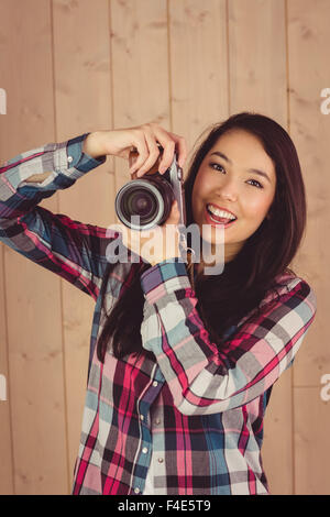 Attractive hipster photographing with camera Stock Photo