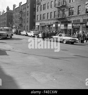 bystanders watching at scene - 1950s cars men wearing hats Stock Photo