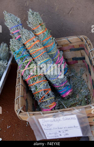 Top view of smudging sticks with dried flowers on a wooden tray Stock Photo