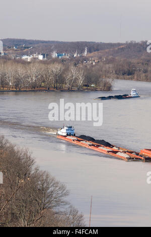 US, West Virginia, Parkersburg. Coal barges navigate up Ohio River seen from historic Fort Boreman Park. Blennerhassett Island in river is historical state park Stock Photo