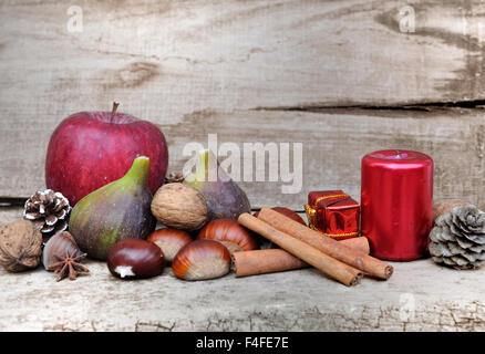 seasonal fruits and Christmas decoration on wooden background Stock Photo