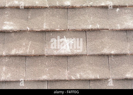 X mark on roof tiles to signify row of tiles to nail to wooden battens to prevent slippage Stock Photo