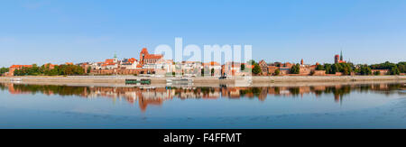 Wide panorama of Torun Old City in Poland with its reflection in Vistula river Stock Photo