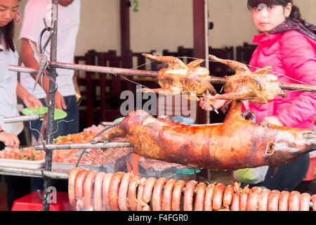 baby pig , chickens and sausages street food being cooked at a restaurant in Sapa north west vietnam,Asia Stock Photo