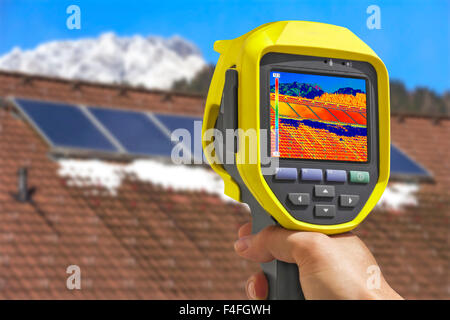 Recording Photovoltaic Solar Panels on the roof House With Thermal Camera Stock Photo