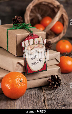 wrapping Christmas presents on an old wooden background in rustic style Stock Photo