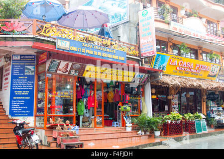 Sapa, north west Vietnam frontier town, mountain hiking clothes store for the trekking in the area and italian pizza restaurant. Stock Photo