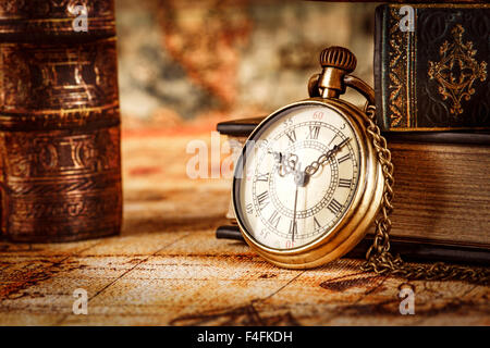 Vintage Antique pocket watch on the background of old books Stock Photo