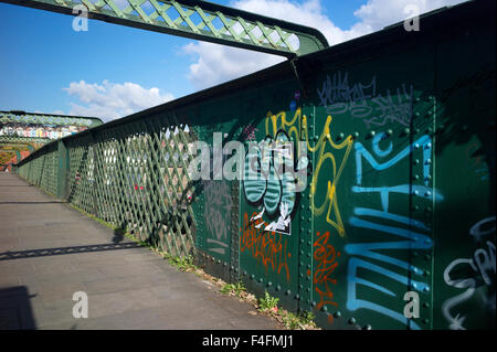 Graffiti on an iron pedestrian bridge, UK Stock Photo