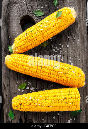 Delicious grilled corn on a wooden board Stock Photo