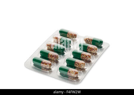 Green pills in a blister package on white background Stock Photo