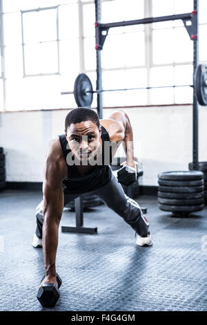 Fit man working out with dumbbells Stock Photo