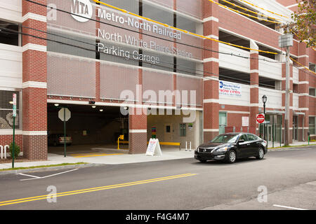 A car passes the Metro-North Railroad North White Plains Station Parking Garage in White Plains, New York. Stock Photo