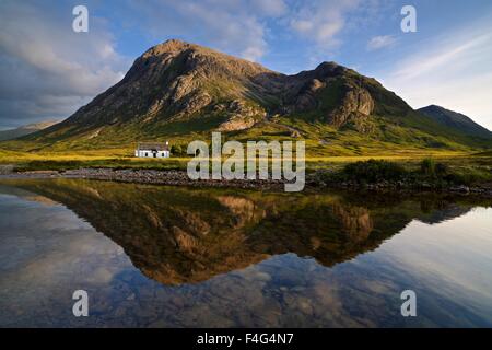 Golden light from the setting sun hits Stob dearg and the still waters of the river coupall Stock Photo