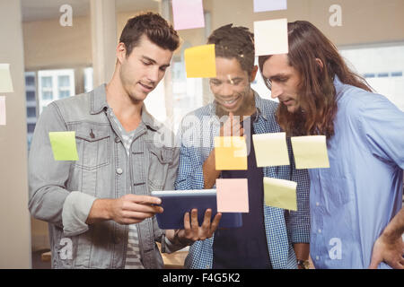 Businessmen discussing over digital tablet Stock Photo