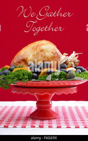 Red and white theme Thanksgiving Table setting with Roast Turkey Chicken on large platter centerpiece. Stock Photo