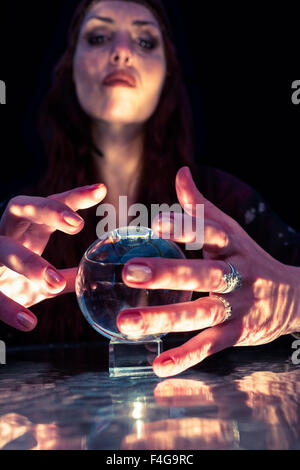 Beautiful young woman with glowing crystal ball Stock Photo - Alamy
