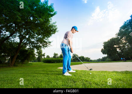Young man playing golf Stock Photo