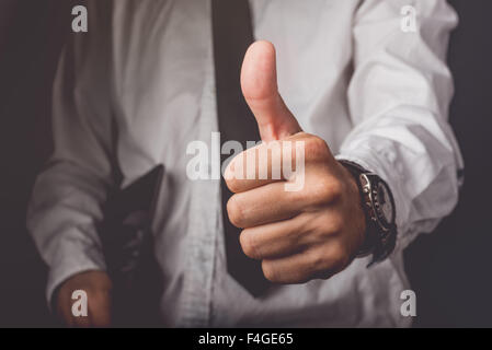 Businessman with thumbs up Stock Photo - Alamy