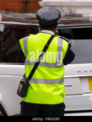 A traffic warden on patrol in London, Britain. Stock Photo