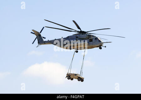 Helicopter CH-53 Super Stallion lifting a hummer vehicle at 2015 Air Show