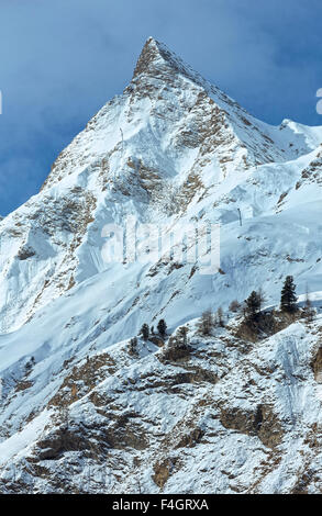 Rock with a pointed top. Winter snowy peaceful Samnaun Alps landscape (Swiss). Stock Photo