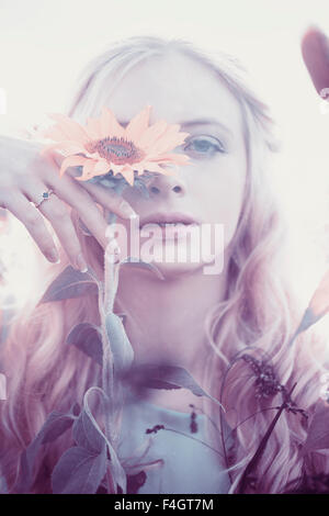 Beautiful blond woman in a sunflower field Stock Photo