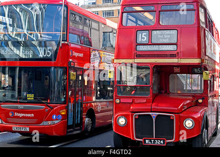 Two red double decker London buses side by side in a street in Whitechapel, East London. Routemaster buses still operate as heritage transport. Stock Photo