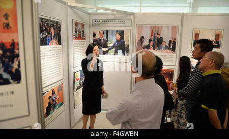 Hong Kong, China. 18th Oct, 2015. Citizens look at photos during a public day of Commission of the Ministry of Foreign Affairs of China in Hong Kong Special Administrative Region (SAR) in Hong Kong, south China, Oct. 18, 2015. More than 2,400 people in Hong Kong visited the commission to learn more about the country's history and foreign policy. Credit:  Qin Qing/Xinhua/Alamy Live News Stock Photo