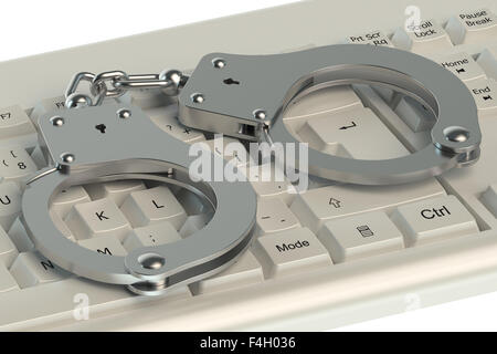 Internet Crime concept, handcuffs on computer keyboard Stock Photo
